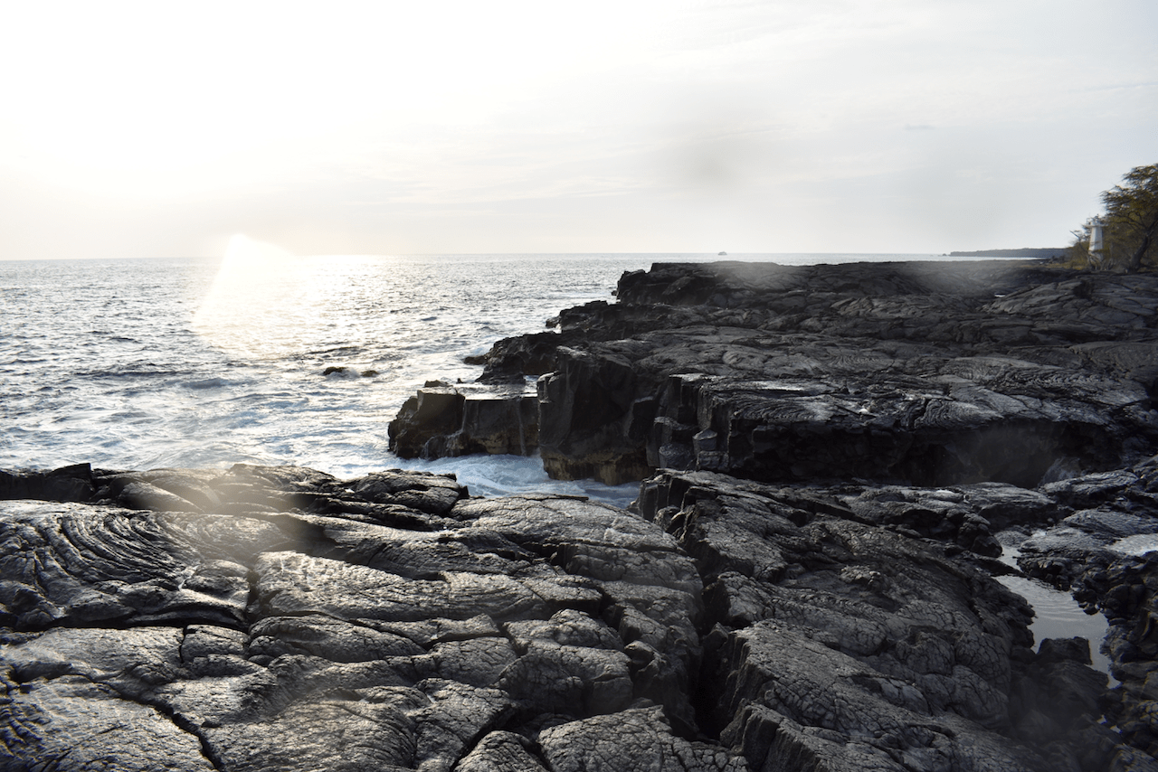 Rocky coastline with ocean waves and sunlight
